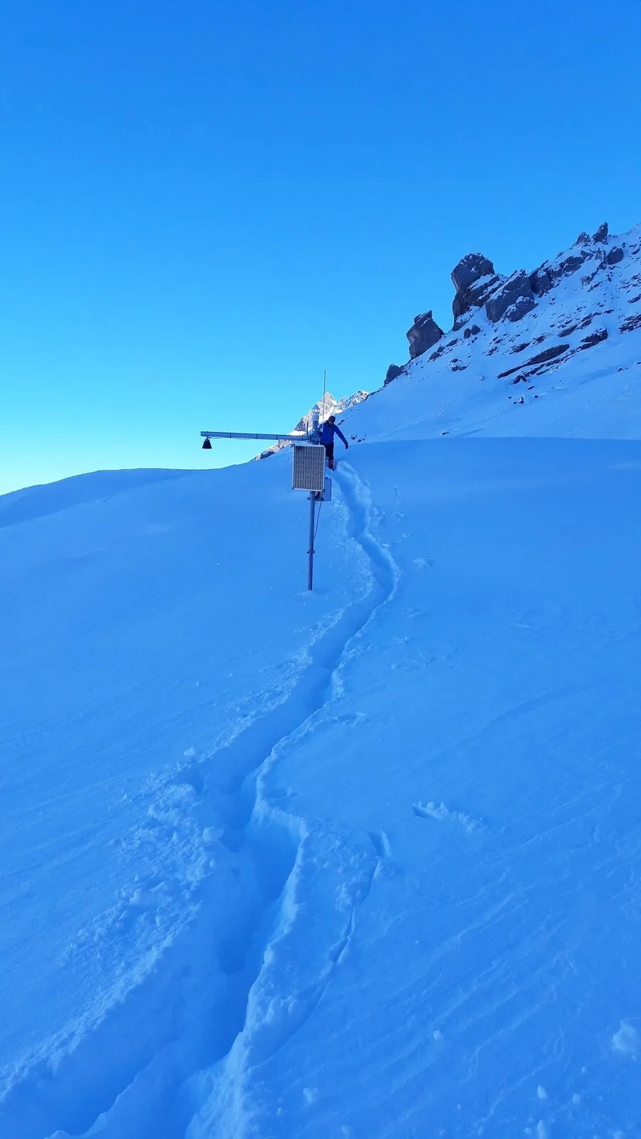 A monitoring station with a solar panel in snow; its design must suit the location.