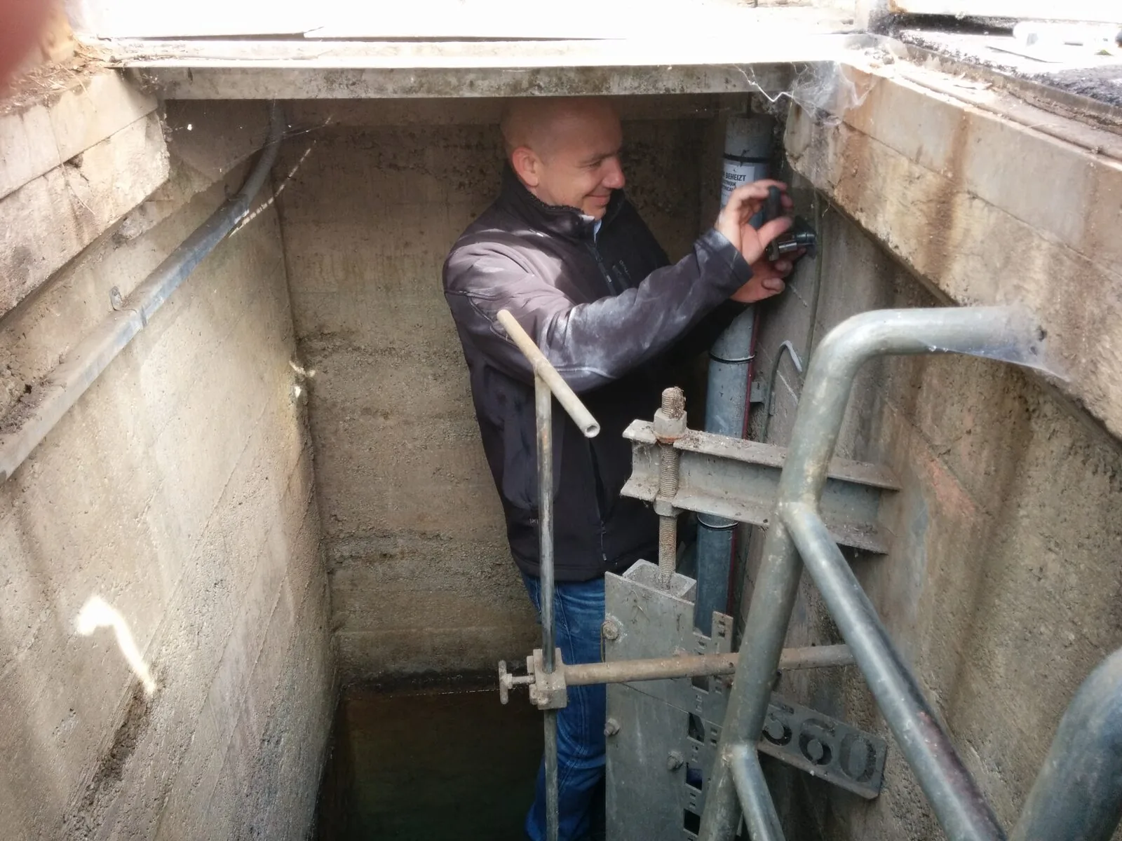 A technician working on monitoring equipment in a chamber.